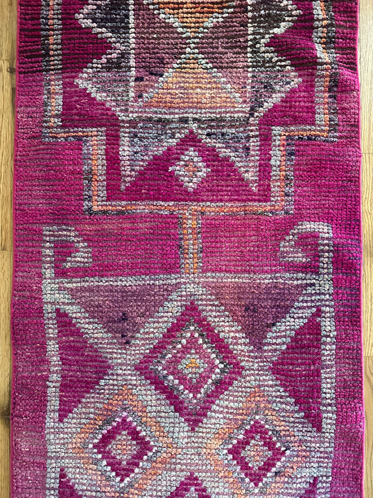 Patterned rug with geometric design on a wooden floor